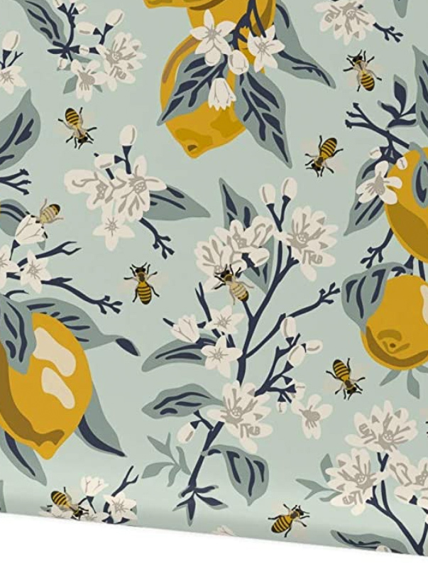 Lemon, bee and flower patterned wallpaper on a mint green background. 